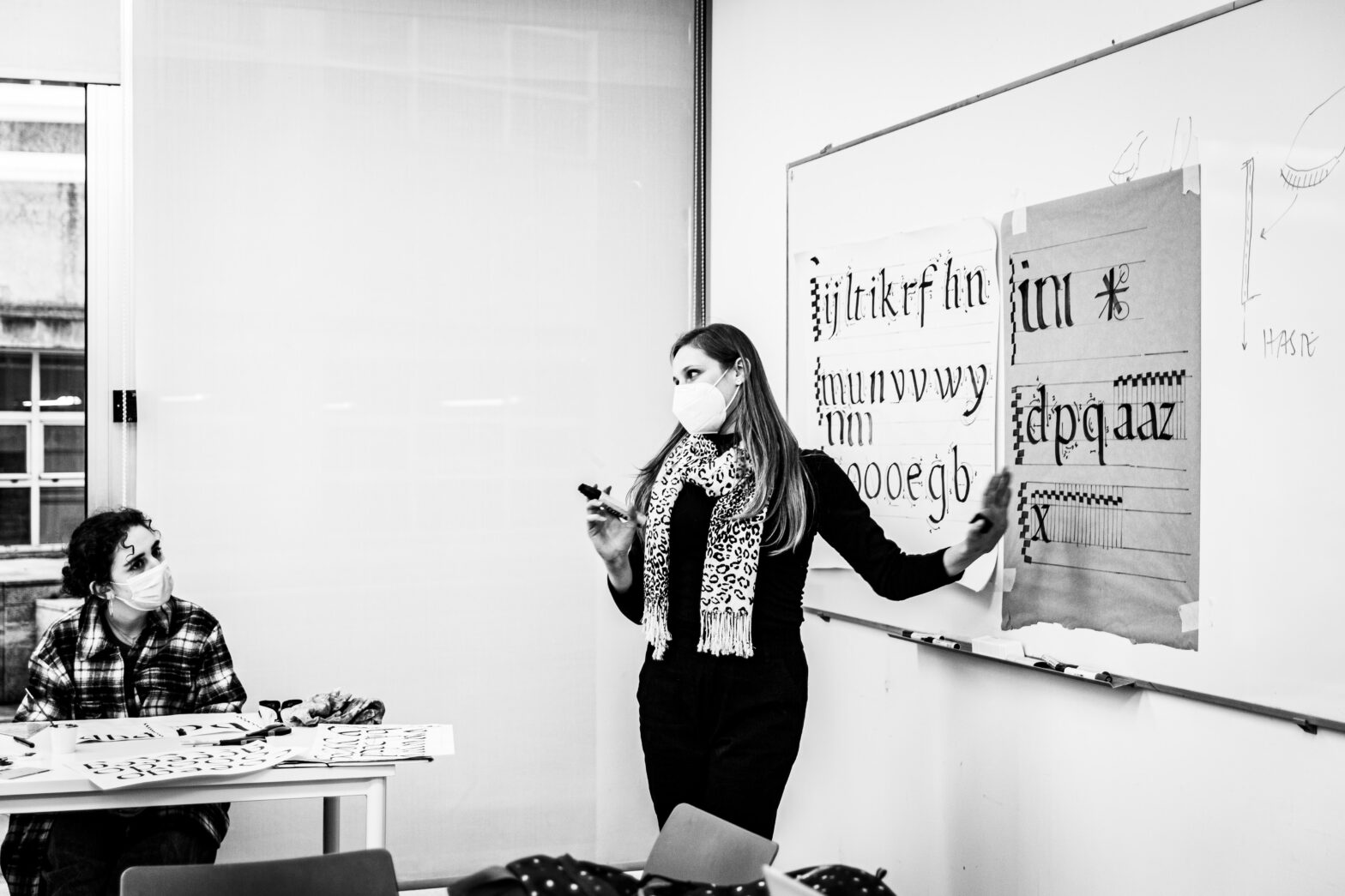 Instructor presenting draings on whiteboard